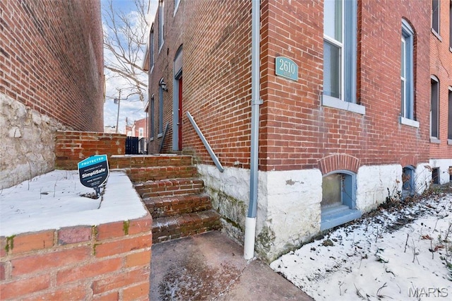 2610 Rutger St, Saint Louis, MO 63104 - view of snow covered exterior featuring brick siding