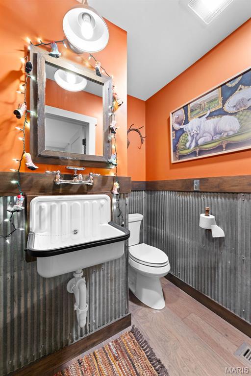727 Madison Vly, Wildwood, MO 63005 - bathroom featuring a wainscoted wall and wood finished floors