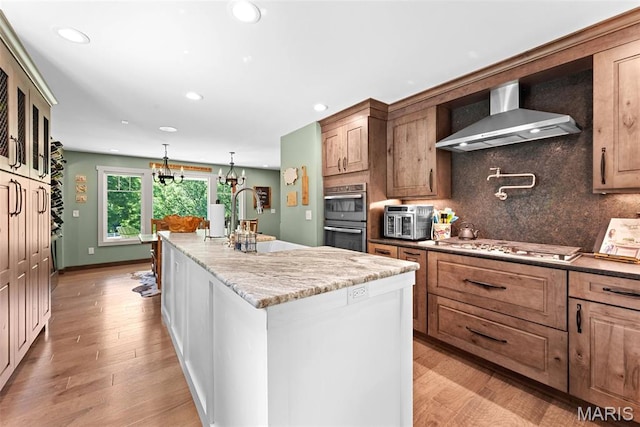 727 Madison Vly, Wildwood, MO 63005 - kitchen featuring wall chimney exhaust hood, a kitchen island, double oven, recessed lighting, and tasteful backsplash