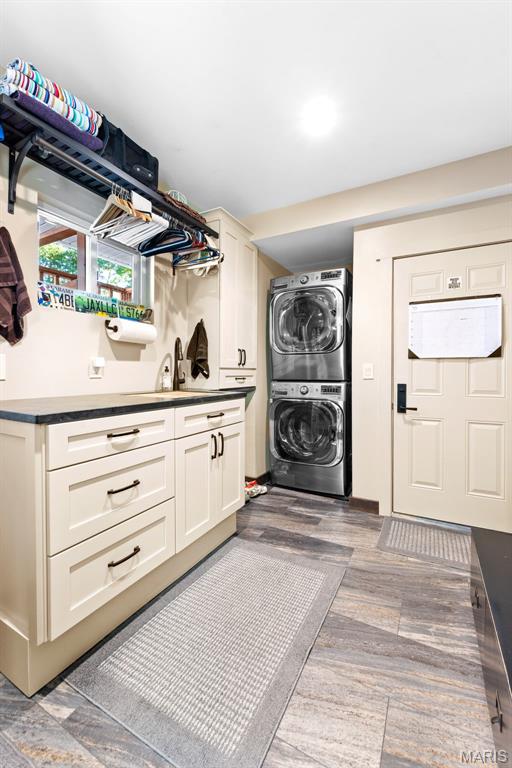 727 Madison Vly, Wildwood, MO 63005 - washroom featuring stacked washer / drying machine and wood finished floors