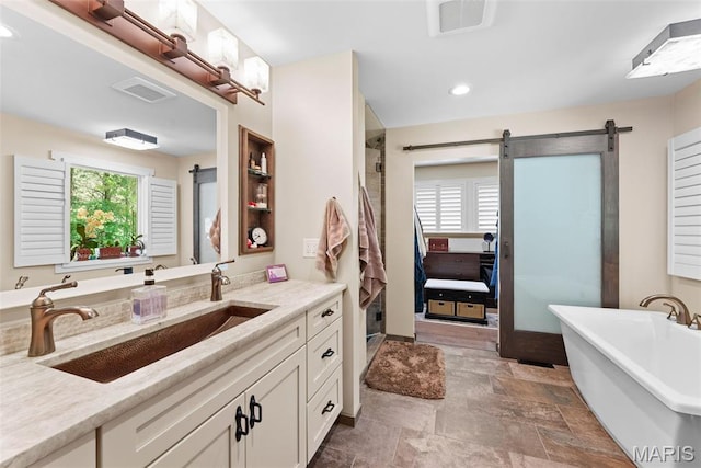 727 Madison Vly, Wildwood, MO 63005 - bathroom with a soaking tub, vanity, a shower with shower door, stone finish flooring, and recessed lighting