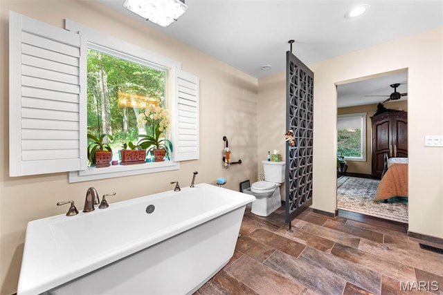 727 Madison Vly, Wildwood, MO 63005 - bathroom featuring stone finish floors, a freestanding bath, connected bathroom, and recessed lighting