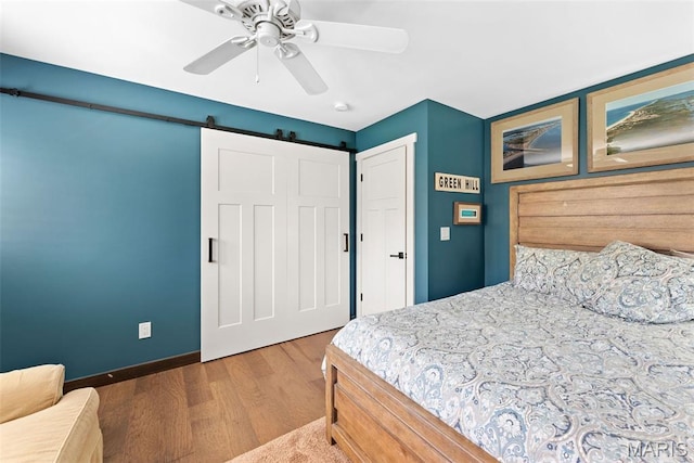 727 Madison Vly, Wildwood, MO 63005 - bedroom with wood finished floors, a barn door, and ceiling fan