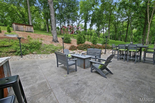 727 Madison Vly, Wildwood, MO 63005 - view of patio with a fire pit, outdoor dining space, and view of wooded area