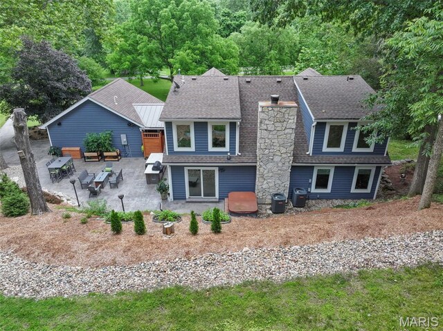 727 Madison Vly, Wildwood, MO 63005 - back of property featuring a patio, roof with shingles, and a chimney