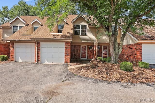 3722 Candlewyck Club Dr D, Unit D, MO 63034 - view of front of home featuring brick siding, driveway, an attached garage, and roof with shingles