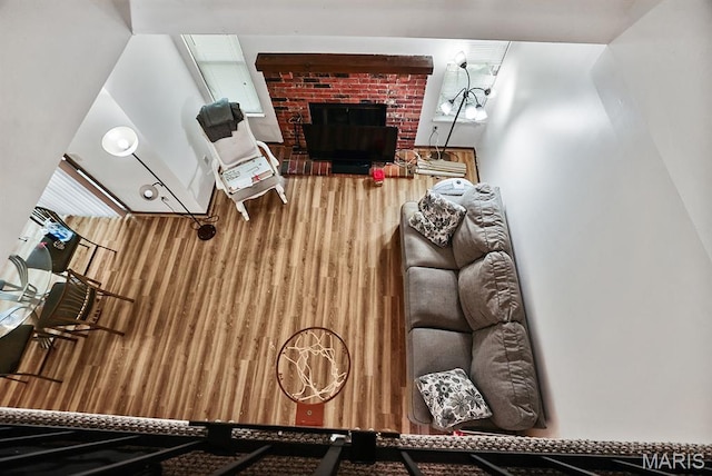 3722 Candlewyck Club Dr D, Unit D, MO 63034 - living room featuring a brick fireplace and wood finished floors