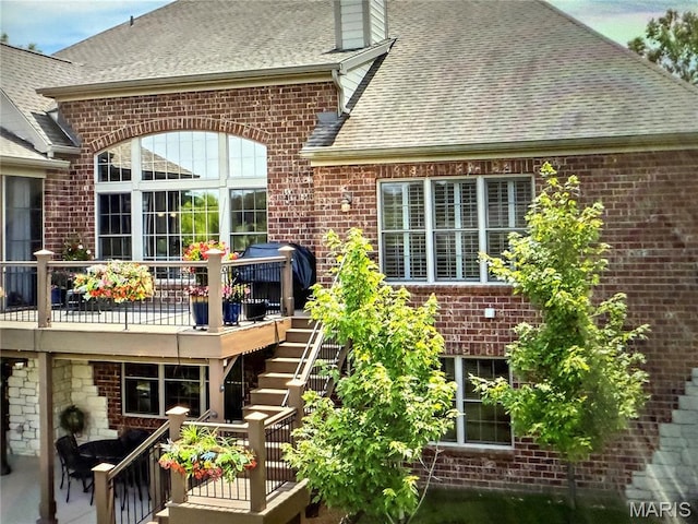 259 Meadowbrook Country Club Est, Ballwin, MO 63011 - rear view of house featuring stairs, brick siding, a shingled roof, and a wooden deck