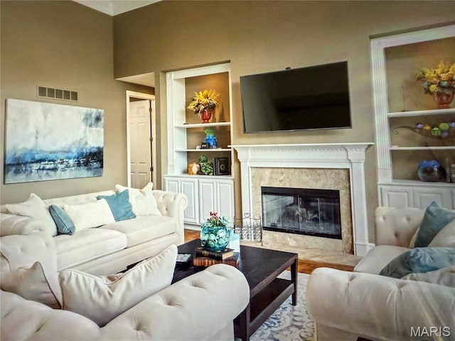 259 Meadowbrook Country Club Est, Ballwin, MO 63011 - living room featuring built in shelves, a high end fireplace, and wood finished floors