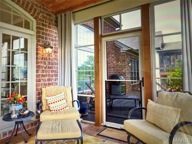 259 Meadowbrook Country Club Est, Ballwin, MO 63011 - sunroom featuring brick wall and wood finished floors