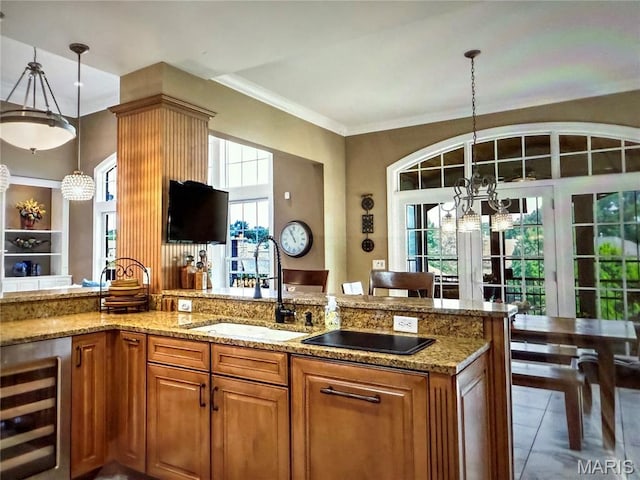 259 Meadowbrook Country Club Est, Ballwin, MO 63011 - kitchen with wine cooler, a chandelier, light stone countertops, brown cabinetry, and ornamental molding