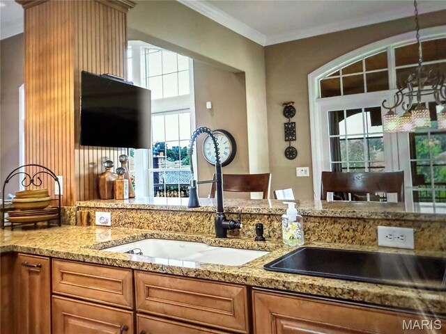 259 Meadowbrook Country Club Est, Ballwin, MO 63011 - kitchen featuring ornamental molding, light stone countertops, and brown cabinets