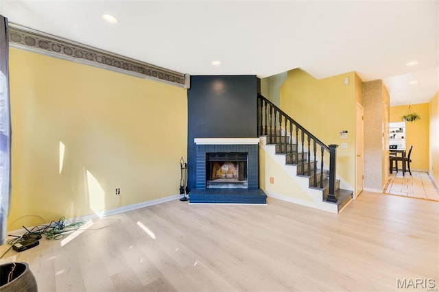 3452 Texas Ave, Saint Louis, MO 63118 - unfurnished living room with wood finished floors, a fireplace, stairway, and recessed lighting