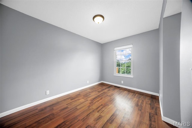 148 Castlewood Dr, Troy, MO 63379 - spare room featuring baseboards and dark wood-style flooring