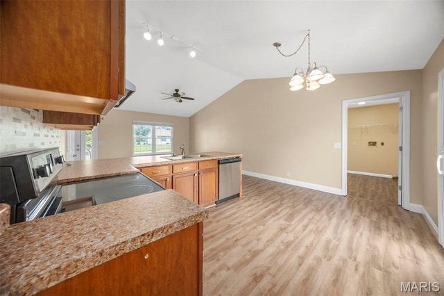 148 Castlewood Dr, Troy, MO 63379 - kitchen featuring brown cabinets, lofted ceiling, a peninsula, appliances with stainless steel finishes, and light countertops