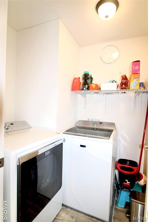 1001 Windsor Crest Ct, Cottleville, MO 63376 - laundry area featuring independent washer and dryer and light wood finished floors