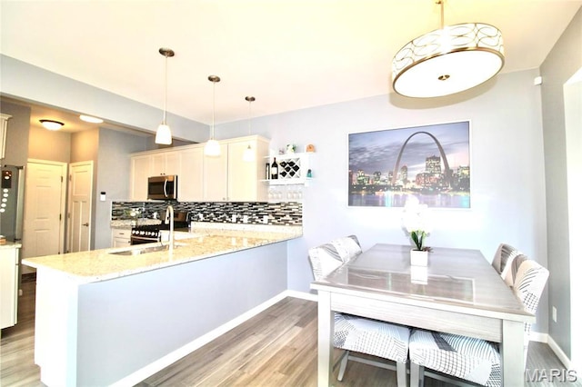 1001 Windsor Crest Ct, Cottleville, MO 63376 - dining space with light wood-style flooring and baseboards
