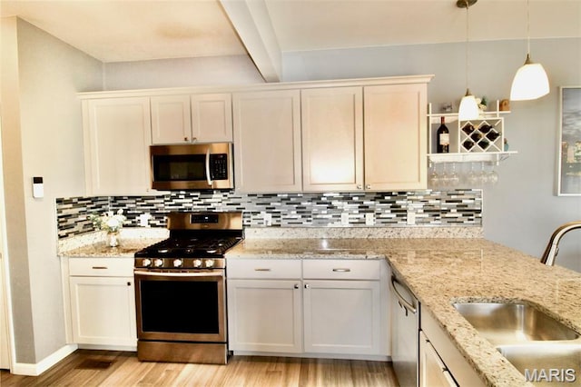 1001 Windsor Crest Ct, Cottleville, MO 63376 - kitchen with stainless steel appliances, light wood-style floors, beamed ceiling, decorative backsplash, and pendant lighting