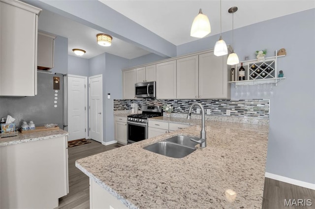 1001 Windsor Crest Ct, Cottleville, MO 63376 - kitchen with stainless steel appliances, open shelves, wood finished floors, decorative backsplash, and light stone counters