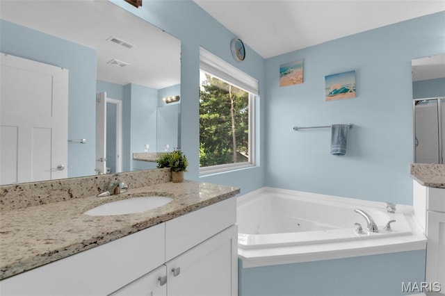 1001 Windsor Crest Ct, Cottleville, MO 63376 - bathroom featuring vanity, a jetted tub, and an enclosed shower