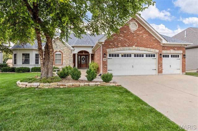 105 Cypress Meadows Dr, Wentzville, MO 63385 - view of front facade with driveway, an attached garage, a front lawn, roof with shingles, and stone siding