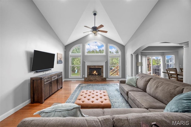 105 Cypress Meadows Dr, Wentzville, MO 63385 - living area featuring ornate columns, a ceiling fan, arched walkways, healthy amount of natural light, and lofted ceiling