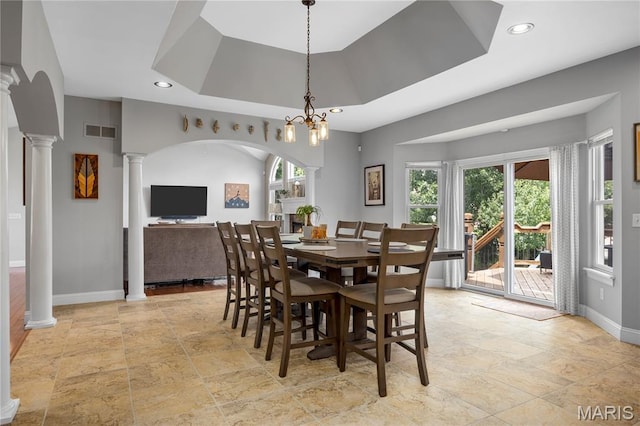 105 Cypress Meadows Dr, Wentzville, MO 63385 - dining area with ornate columns, light stone finish flooring, recessed lighting, a raised ceiling, and arched walkways