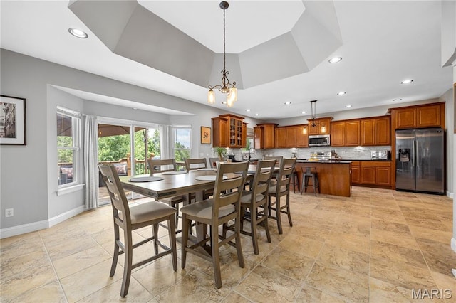 105 Cypress Meadows Dr, Wentzville, MO 63385 - dining room with recessed lighting, a tray ceiling, light stone finish floors, and a chandelier