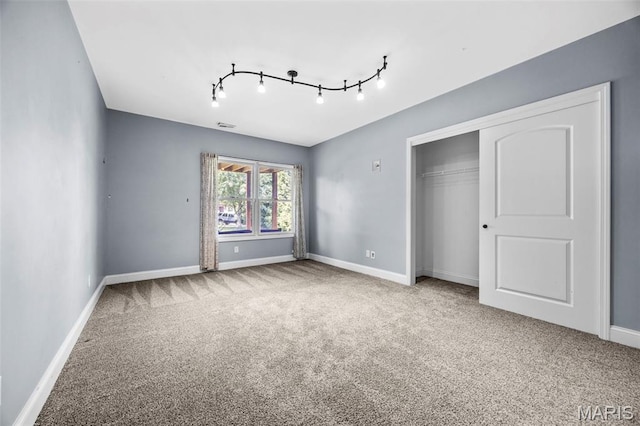 105 Cypress Meadows Dr, Wentzville, MO 63385 - unfurnished bedroom featuring carpet flooring, a closet, and track lighting