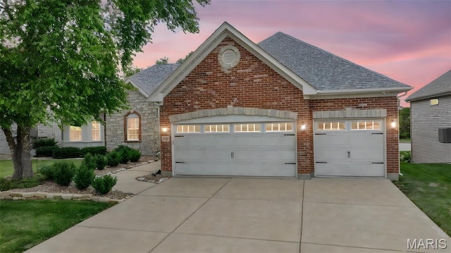 105 Cypress Meadows Dr, Wentzville, MO 63385 - traditional-style home featuring a garage, concrete driveway, roof with shingles, and brick siding