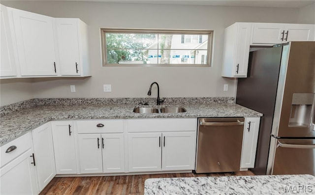 501 W 2nd, Dixon, MO 65459 - kitchen with stainless steel appliances, white cabinets, wood finished floors, and light stone countertops