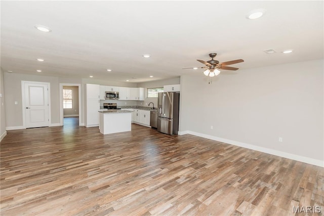 501 W 2nd, Dixon, MO 65459 - unfurnished living room with recessed lighting, wood finished floors, and ceiling fan