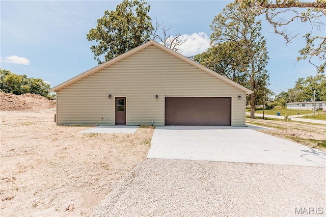 501 W 2nd, Dixon, MO 65459 - view of side of home featuring gravel driveway and an attached garage