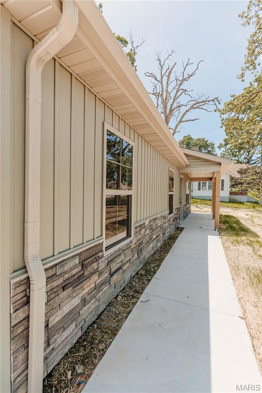 501 W 2nd, Dixon, MO 65459 - view of property exterior with stone siding and board and batten siding