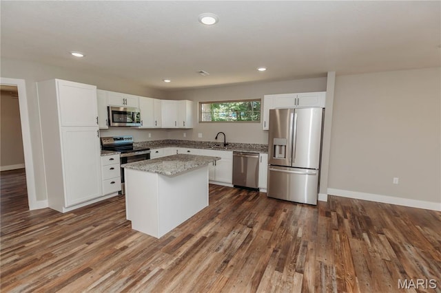 501 W 2nd, Dixon, MO 65459 - kitchen featuring stainless steel appliances, dark wood finished floors, white cabinetry, a center island, and recessed lighting