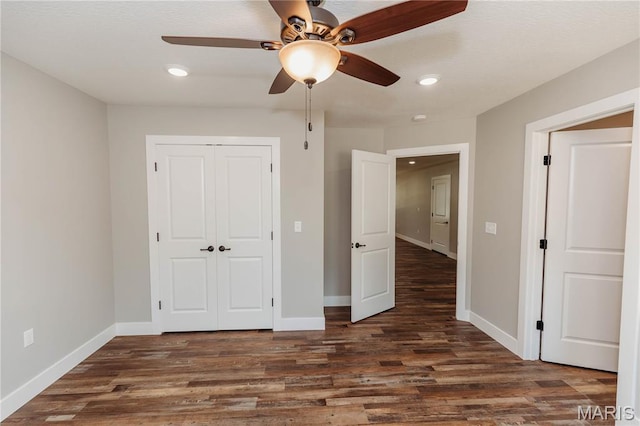 501 W 2nd, Dixon, MO 65459 - unfurnished bedroom with a closet, dark wood-type flooring, recessed lighting, and ceiling fan