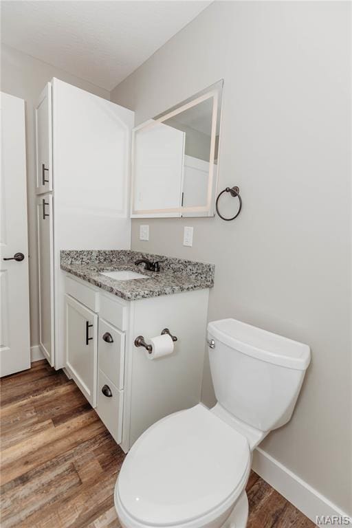501 W 2nd, Dixon, MO 65459 - half bathroom featuring vanity and wood finished floors