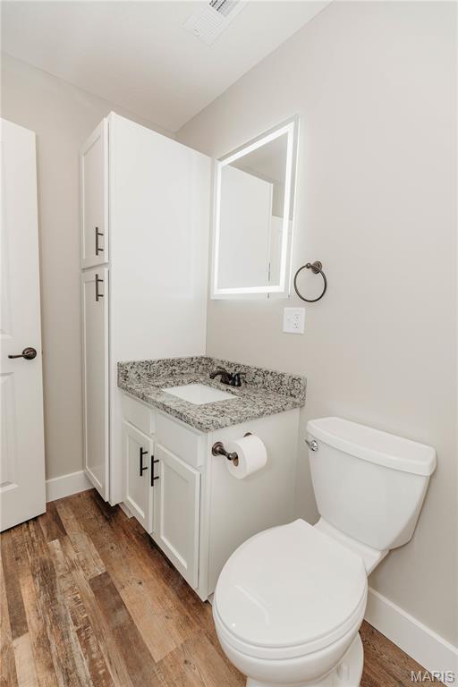 501 W 2nd, Dixon, MO 65459 - half bath with vanity and wood finished floors
