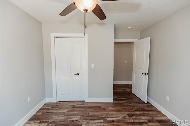 501 W 2nd, Dixon, MO 65459 - unfurnished bedroom featuring dark wood-style flooring, a closet, and a ceiling fan