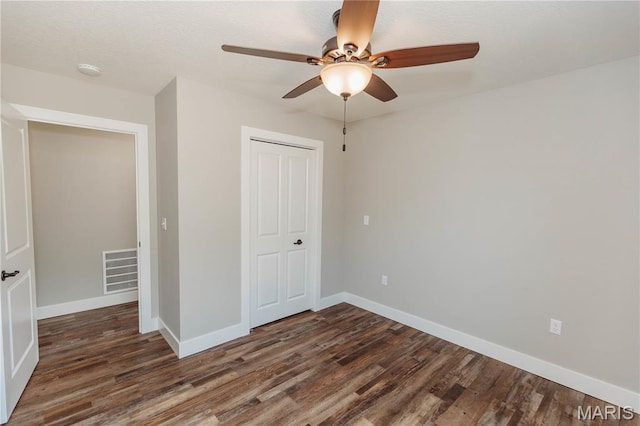 501 W 2nd, Dixon, MO 65459 - unfurnished bedroom with wood finished floors, a closet, and ceiling fan