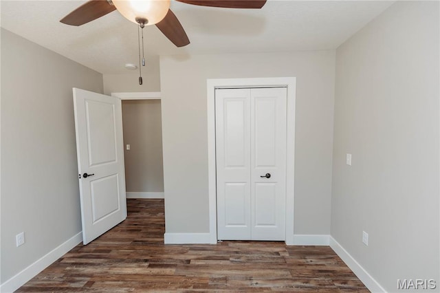 501 W 2nd, Dixon, MO 65459 - unfurnished bedroom featuring wood finished floors, a closet, and a ceiling fan