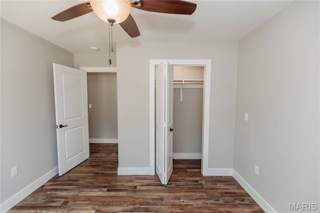 501 W 2nd, Dixon, MO 65459 - unfurnished bedroom featuring wood finished floors, a closet, a ceiling fan, and a spacious closet
