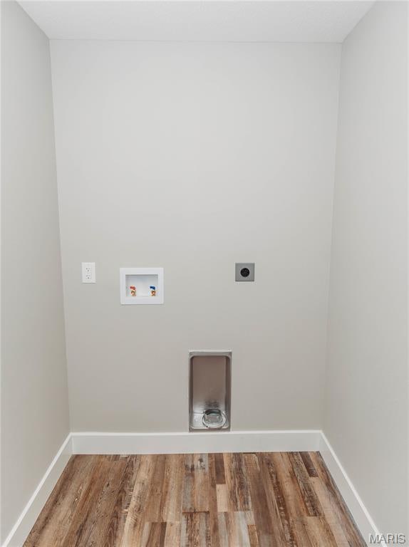 501 W 2nd, Dixon, MO 65459 - laundry area with hookup for an electric dryer, hookup for a washing machine, and wood finished floors