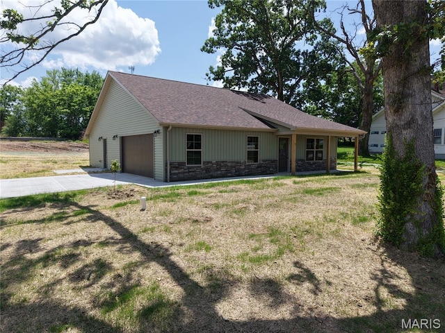501 W 2nd, Dixon, MO 65459 - view of front of property featuring a garage, stone siding, driveway, roof with shingles, and a front yard