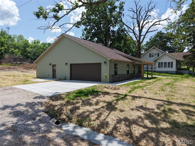 501 W 2nd, Dixon, MO 65459 - view of property exterior featuring an attached garage, driveway, and stone siding