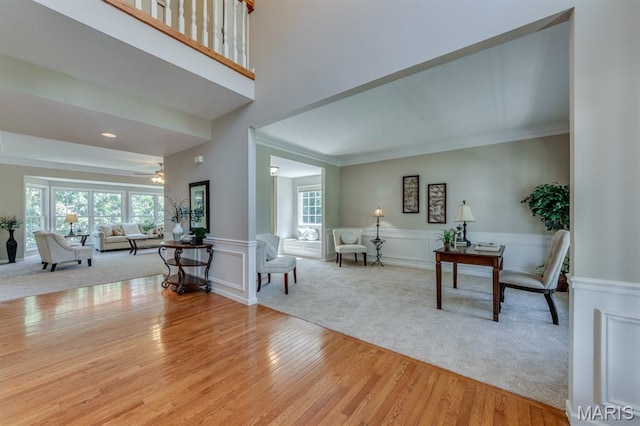 1515 Dietrich Glen Dr, Ballwin, MO 63021 - carpeted living room with ornamental molding, wood finished floors, a decorative wall, and a wainscoted wall