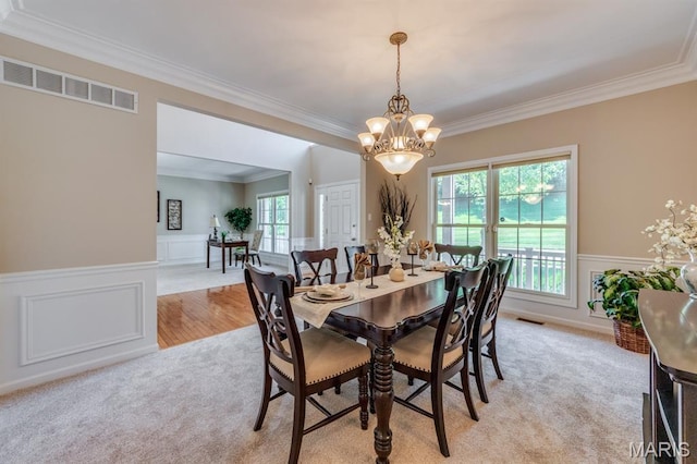 1515 Dietrich Glen Dr, Ballwin, MO 63021 - dining room with ornamental molding, a chandelier, light colored carpet, wainscoting, and a decorative wall