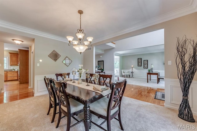 1515 Dietrich Glen Dr, Ballwin, MO 63021 - dining space with ornamental molding, a chandelier, wainscoting, light wood-type flooring, and light carpet