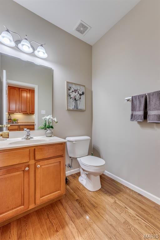 1515 Dietrich Glen Dr, Ballwin, MO 63021 - half bath featuring wood finished floors and vanity