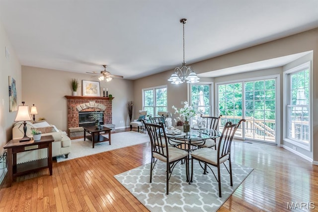 1515 Dietrich Glen Dr, Ballwin, MO 63021 - dining space with light wood-style flooring, plenty of natural light, and a fireplace